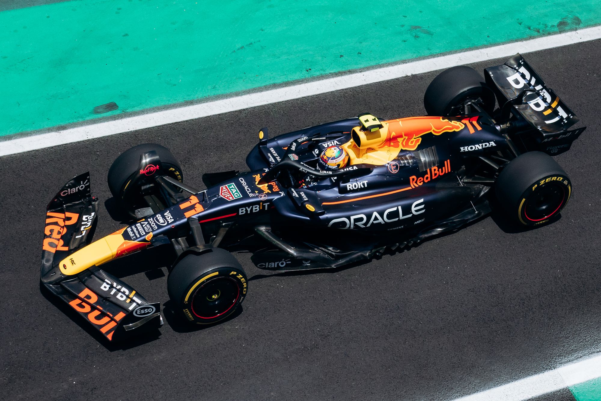 Formula 1 car on track with race flags in the background